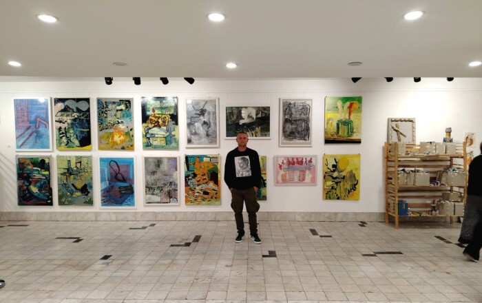 Aleksandar in front of his work